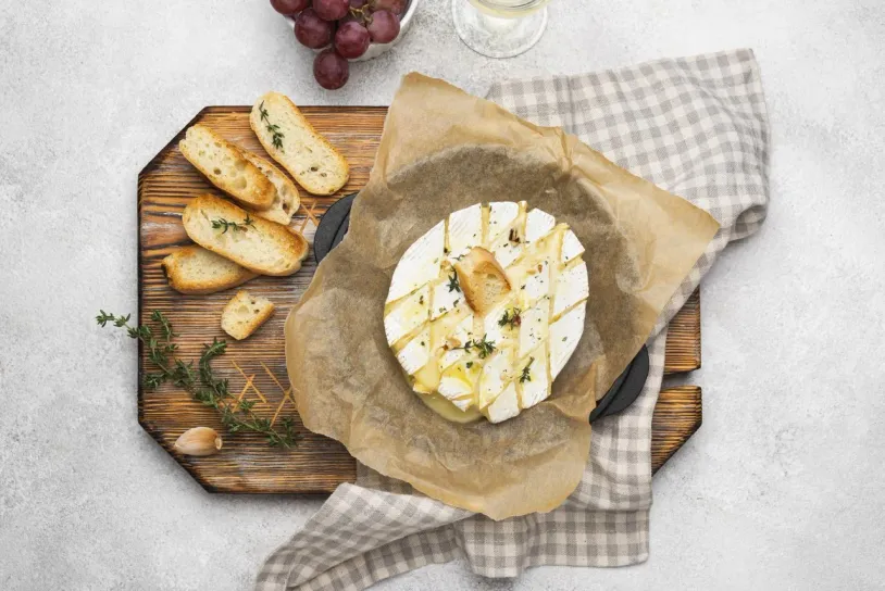 Camembert and bread on a chopping block
