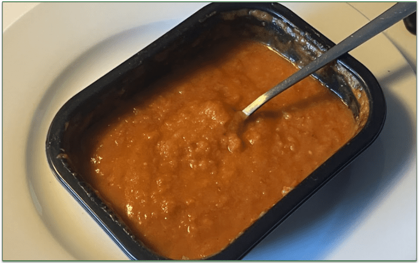 Photo of Nutrisystem's Creamy Tomato Soup in a microwaveable container with a spoon