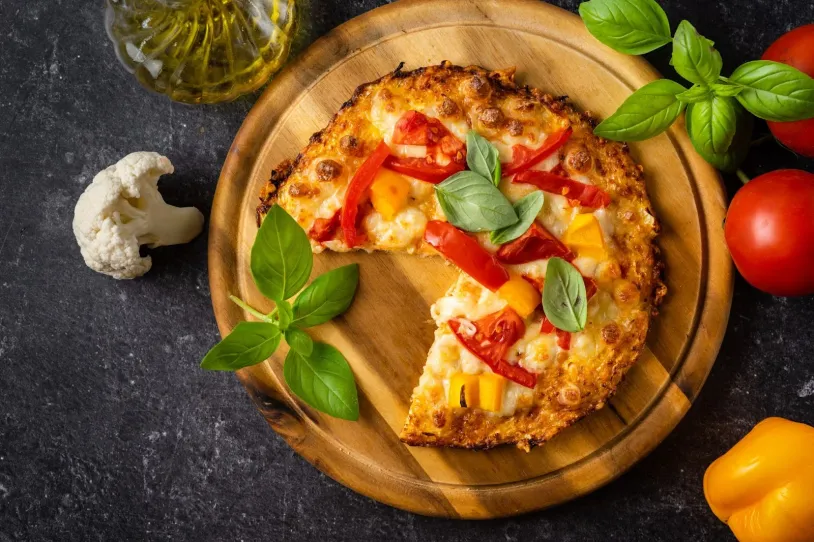 A pizza with a hash brown crust on a serving platter