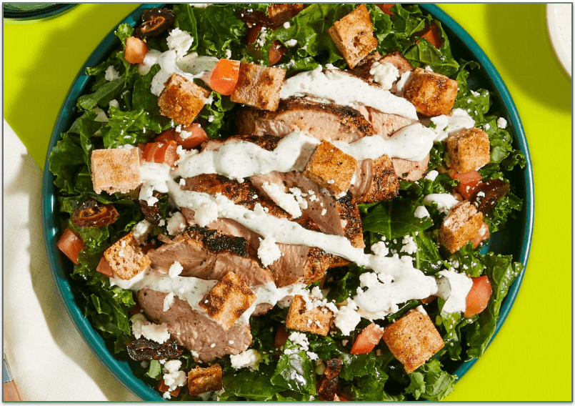Green Chef's Gyro-Spiced Pork Tenderloin Kale Salad with Garlicky Croutons, Tomato, Feta, and White Balsamic Vinaigrette