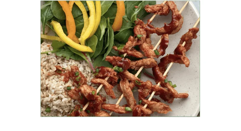 MamaSezz's BBQ protein strips on a plate with rice and salad