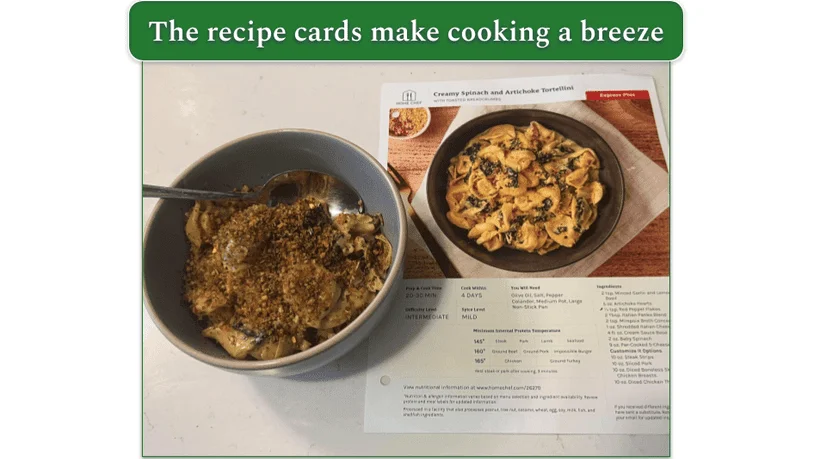 Creamy spinach and artichoke tortellini in a bowl from Home Chef with the recipe card next to it