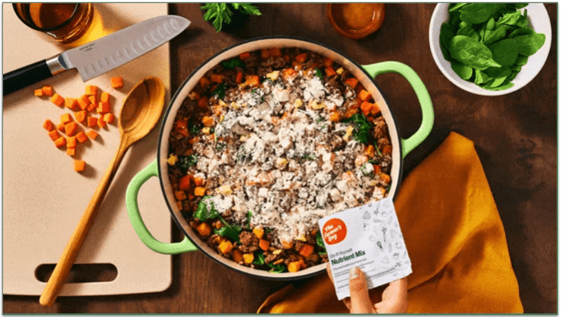 TFD's nutrient mix being added to a pot of homecooked dog food