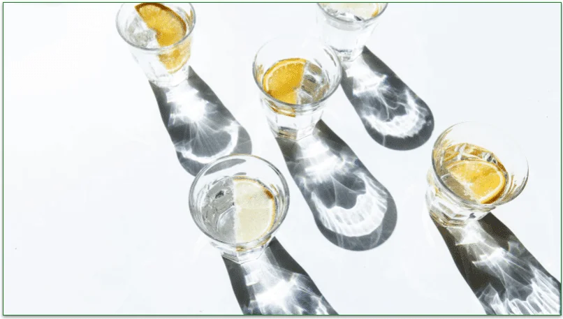 Several glasses of water garnished with lemon slices