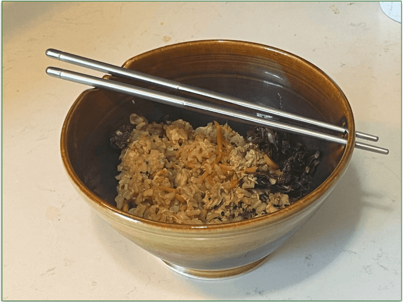 Korean inspired chicken heated up by our reviewer in a bowl with chop sticks