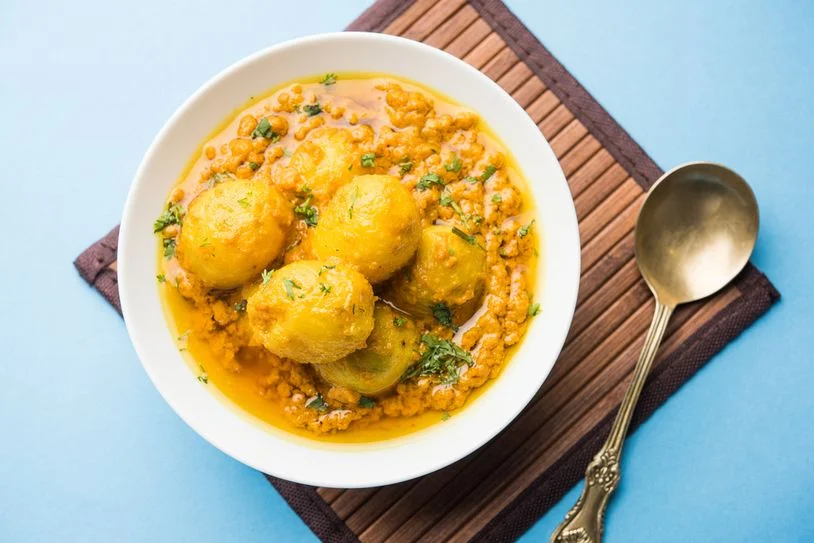 Bengali dum aloo in a bowl with a spoon