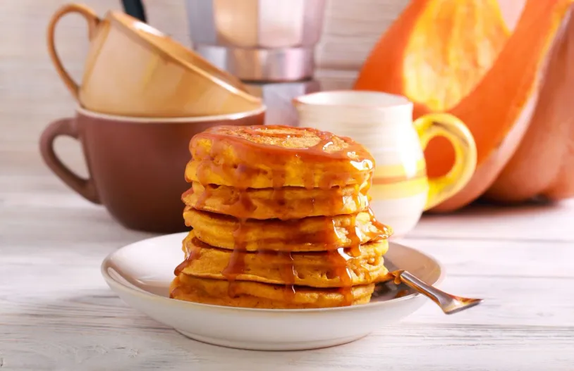 Pumpkin pancakes topped with caramel sauce