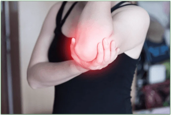 A woman holding her elbow due to joint pain.