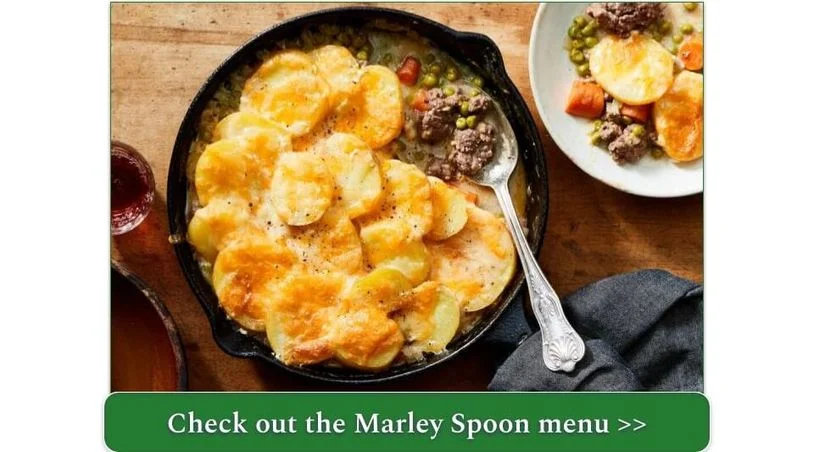 A skillet with ground beef topped with roasted sliced potatoes