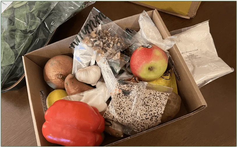 Photo of produce and items that don't need refrigeration in a cardboard storage tray