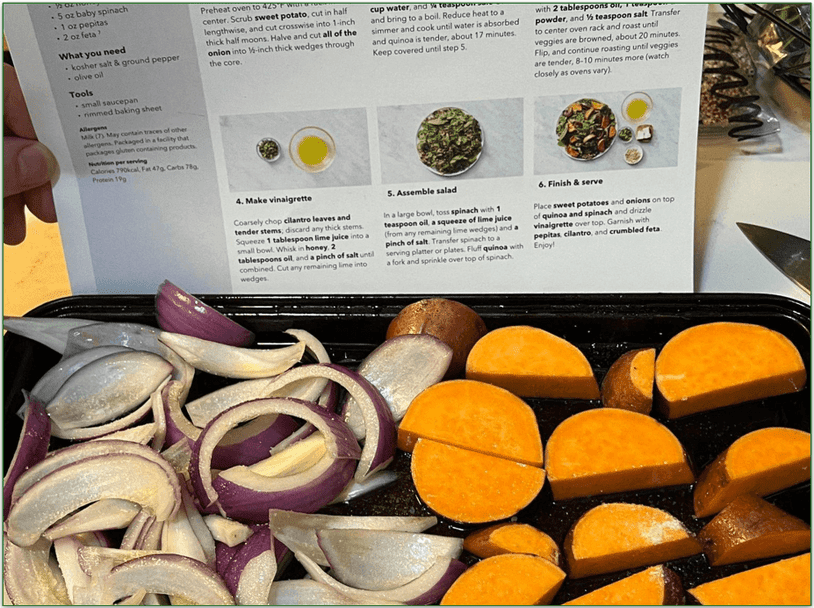 Marley Spoon recipe card with a tray of chopped vegetables in front of it