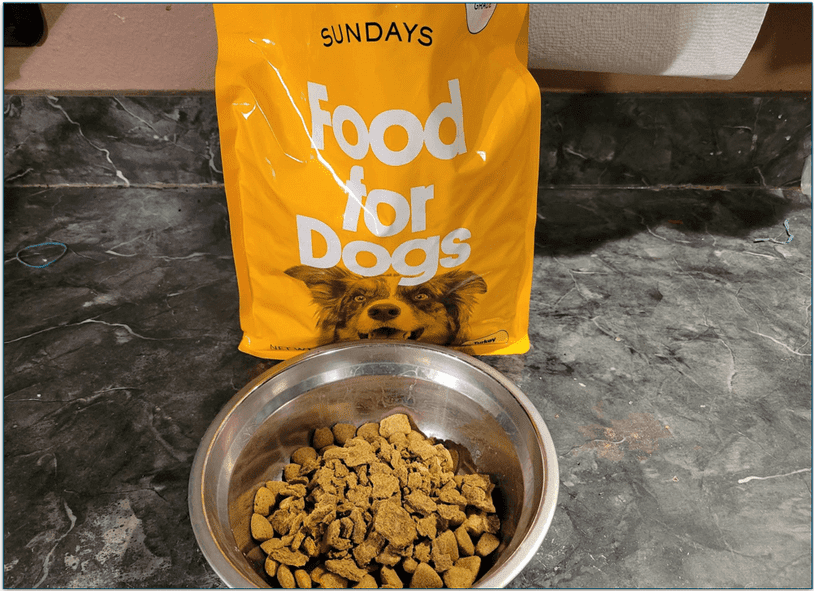 Bowl of dog food in front of a Sundays food bag
