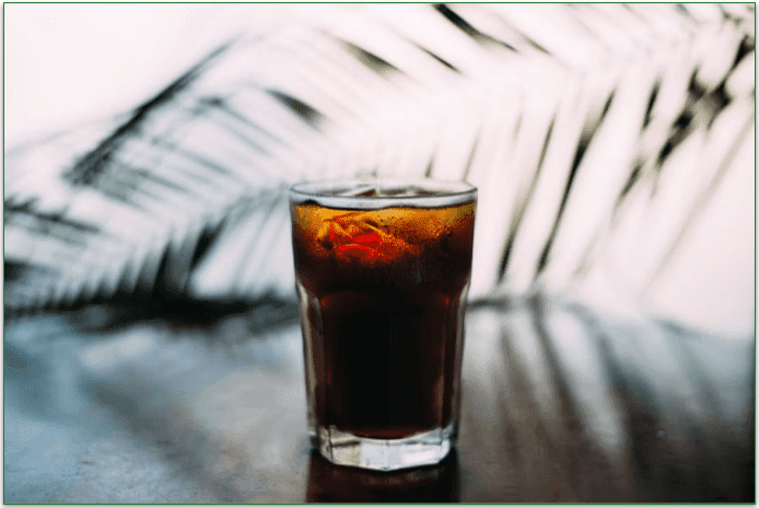 A glass of soda on a table.