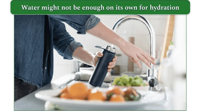 a picture of someone filling up a water bottle