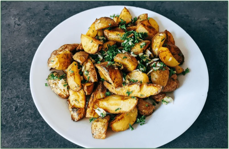 Crispy garlic roasted potatoes on a plate