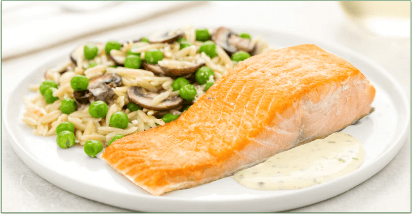 A plate of a slice of salmon with a side of rice and veggies, depicting a recipe option from Home Chef