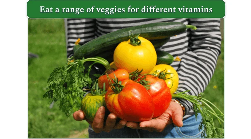 Person holding colorful vegetables