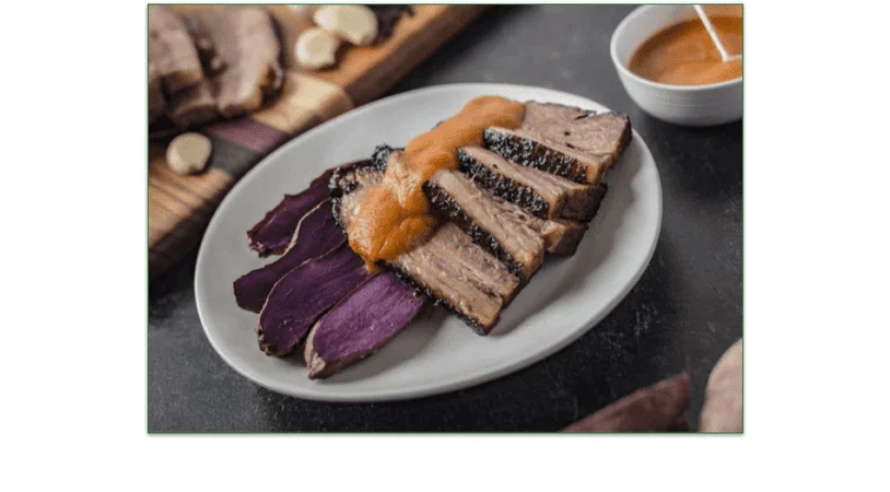 Sliced smoked brisket with sweet potatoes