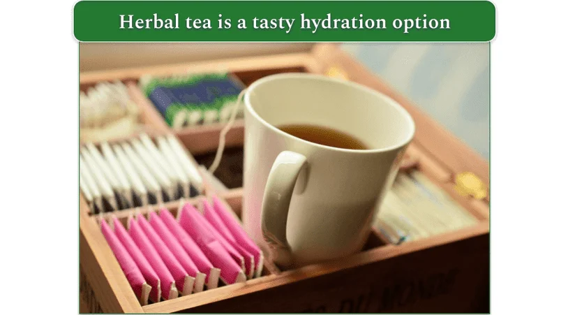 Cup of herbal tea with a range of herbal teas in a box