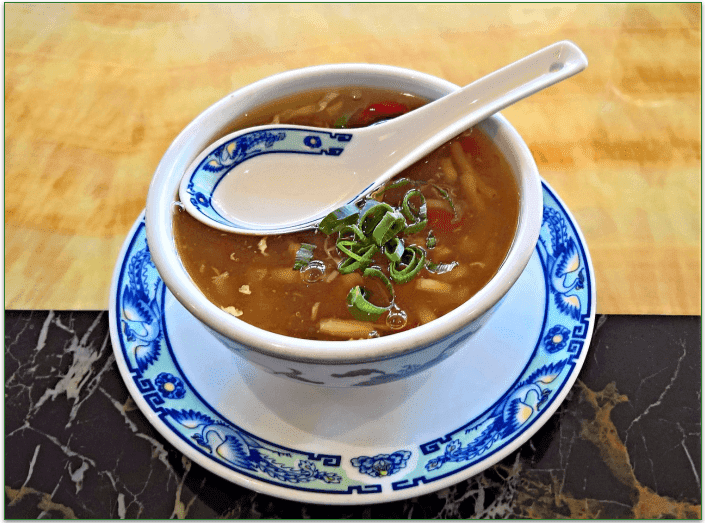 Bowl of miso soup with a serving spoon