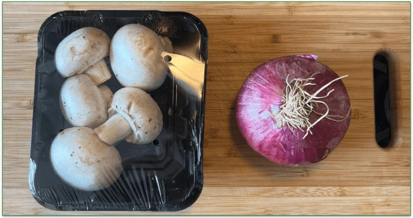 HelloFresh mushrooms and an onion on a chopping board