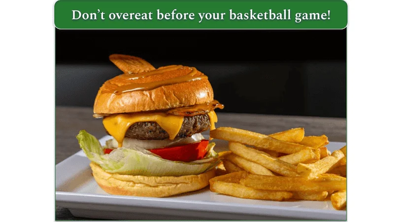 a burger with cheese on a bun with lettuce and tomato on plate with fries