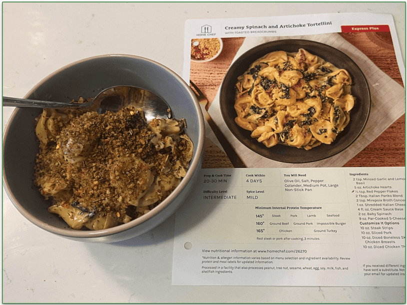 Creamy spinach and artichoke tortellini in a bowl from Home Chef with the recipe card next to it