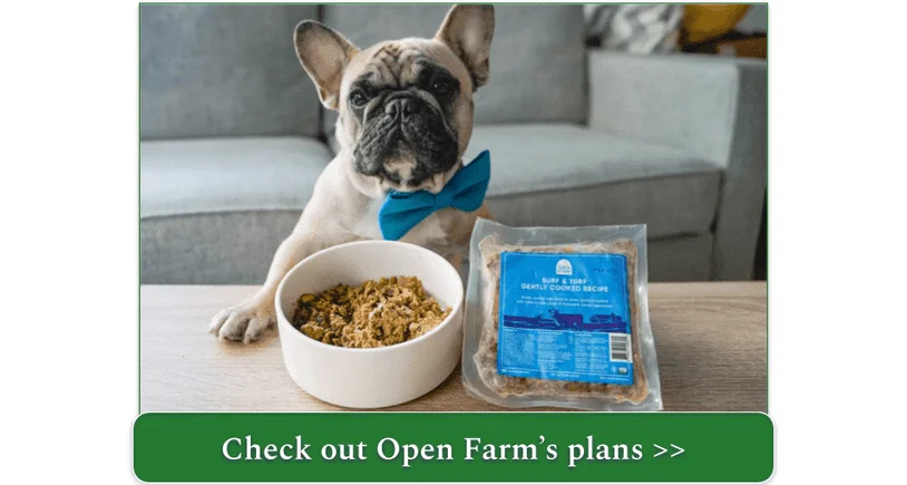 A French Bulldog in a blue bowtie sits in front of a bowl and a package of Open Farm's Surf & Turf Gently Cooked Recipe