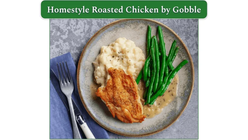 A plate of chicken, mashed potatoes and green beans