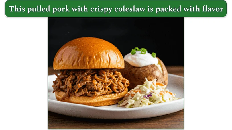 pulled pork on a brioche, baked potato with sour cream and chives, and coleslaw