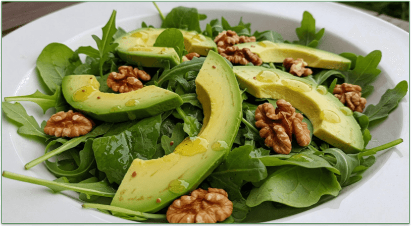 A bowl of arugula, avocado, and walnut salad with homemade dressing.