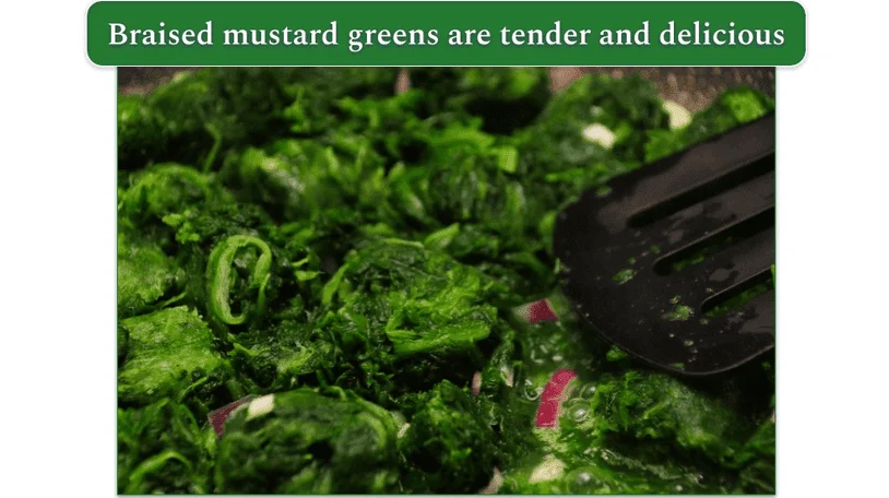 Sake-Braised Mustard Greens in a pan, while cooking
