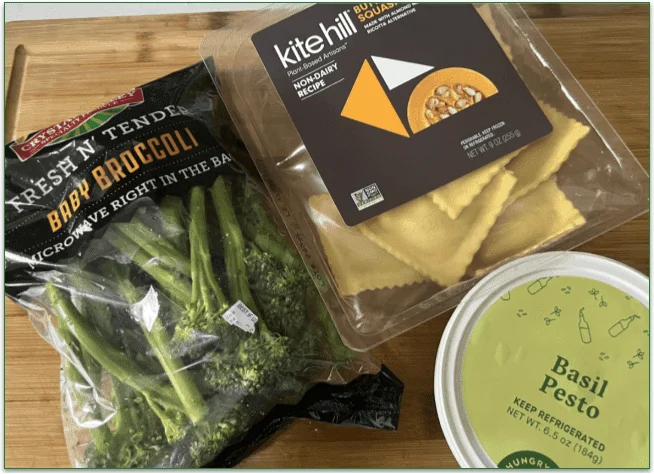 Bag of baby broccoli, non-dairy ravioli, and basil pesto