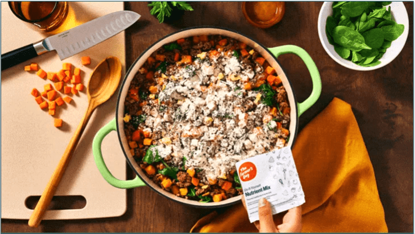 TFD's nutrient mix being added to a pot of DIY dog food