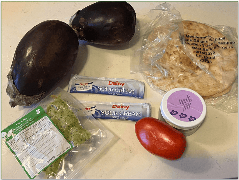 Whole vegetables on a wooden chopping board from a Dinnerly order