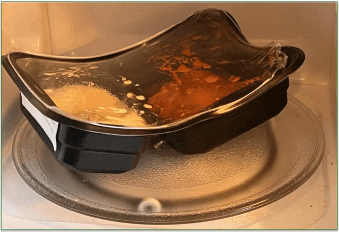 Image of a meal in the microwave with a warped plastic container