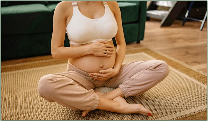 Pregnant woman sitting cross-legged