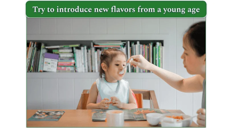 Young child in high chair being spoon-fed