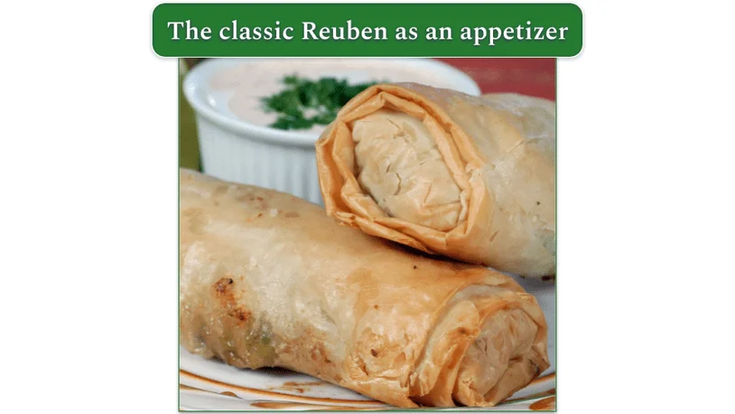 2 Reuben Egg Rolls, on a plate, served with a dipping sauce