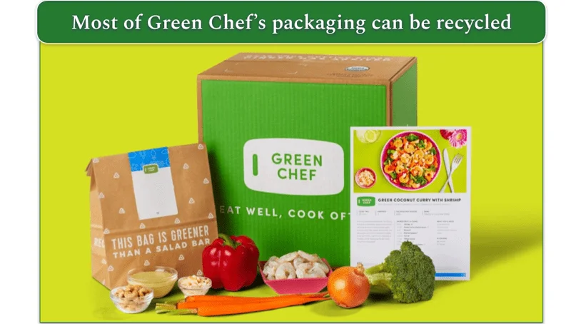 Image of a Green Chef delivery box with paper recipe packaging, a recipe card, and some vegetables displayed next to it