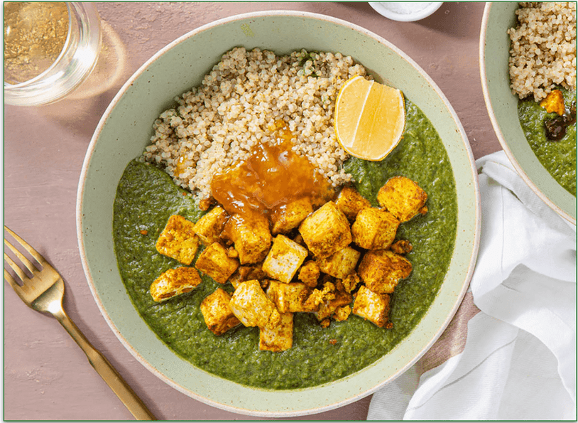 A bowl of spinach and brown rice with tofu